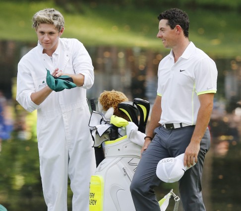 One Direction's Niall Horan caddied for Rory McIlroy. Photo: EPA