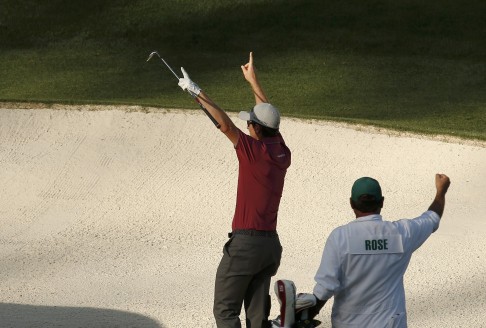 Rose and his caddie celebrate a chip-in from the sand on 16. Photo: Reuters