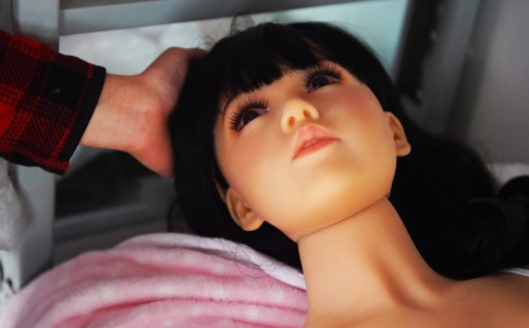 A salesman positions the head of a Micdolls sex doll in Beijing.  Economic reforms in China have brought the country more sexual freedom, and a plethora of sex shops. Photo: AFP
