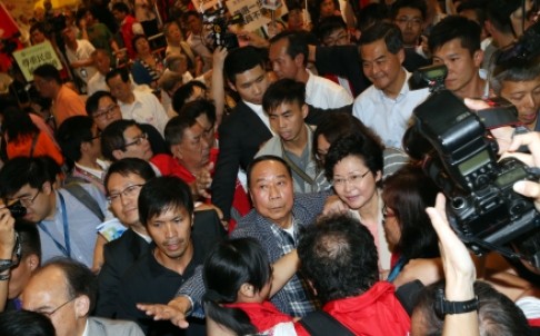 Chief Executive Leung Chun-ying and his deputy, Carrie Lam Cheng Yuet-ngor, were mobbed by rowdy protesters as they launched a publicity campaign on Wednesday in Kowloon. Photo: David Wong