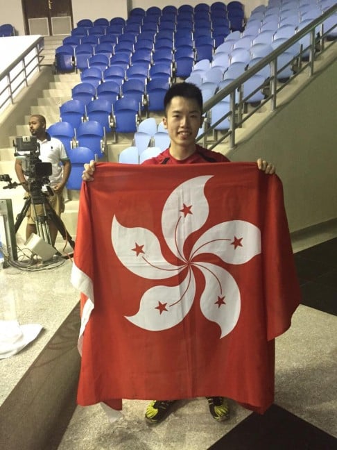 Leo Au with the Bauhinia flag after his victory.