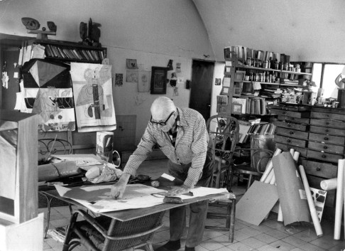 Le Corbusier working in his atelier in Paris.