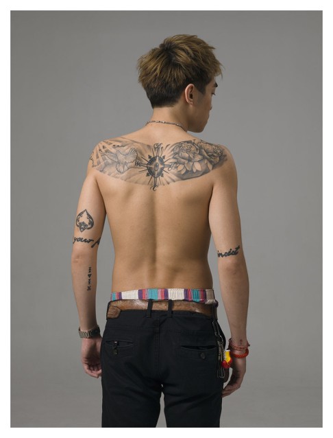 The large monochromatic tattoo on Sonny's back illustrates his relationship with his family.  Each family member is represented by points of the compass, which combine to give Sonny the sense of them coming together.