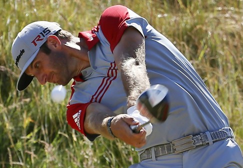 Dustin Johnson hits his tee shot on the seventh hole. Photo: AP