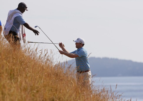 Branden Grace gets a club from his caddie on the 12th hole. Photo: AP