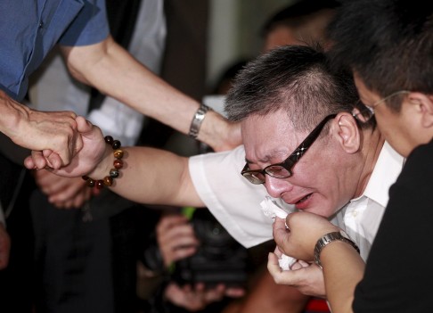 The father of a victim injured in a fire at the Formosa Fun Coast water park cries at Taipei Veterans General Hospital in Taipei. Photo: Reuters