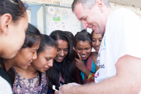 John Wood shares a light moment with Room to Read programme members at the school in Sankhu. Photo: Rishi Amatya/Room to Read
