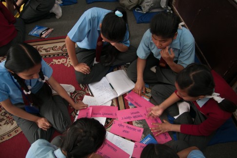 Students in a health class, part of Room to Read's life skills education, at a school in Kathmandu. Written on each pink slip is a health problem, and the girls are discussing how to prevent such problems. Photo: Rishi Amatya/Room to Read
