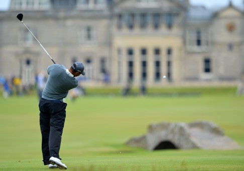 Tiger Woods manages to keep his ball out of the Swilcan Burn. Photo: AFP