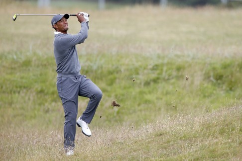 Tiger Woods plays out of the rough. Photo: PA