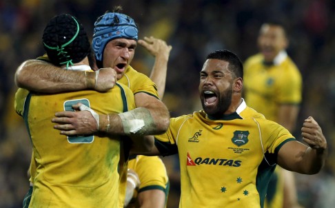 Wallabies lock James Horwill (centre) celebrates with team-mates including Scott Sio (right) after the win over South Africa. Photo: Reuters