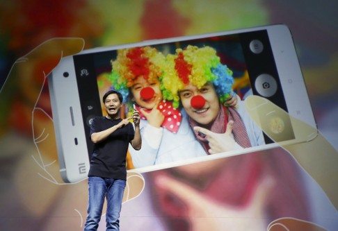 Xiaomi CEO Lei Jun demonstrates the new features of the Chinese brand's Phone 4 at its launch in Beijing in December. Photo: Reuters