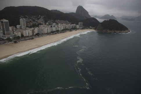 This July 27, 2015 aerial photo shows Copacabana Beach in Rio de Janeiro, Brazil. Water quality monitoring was supposed to be beefed up along the city’s picture postcard beaches, including Copacabana, where the marathon swimming competition is to be staged. An Associated Press analysis of the water quality showed the beach waters laden with sewage viruses. (AP Photo/Leo Correa)