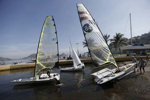 In this July 16, 2015 photo, members of Austria's Olympic sailing team train in the Rio de Janeiro municipality Niteroi, Brazil. "This is by far the worst water quality we've ever seen in our sailing careers," said Austria's coach Ivan Bulaja. The Austrian sailors take precautions, washing their faces immediately with bottled water when they get splashed by waves and showering the minute they return to shore. (AP Photo/Silvia Izquierdo)