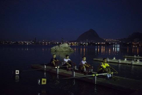 In this July 13, 2015 photo, athletes practice rowing on a deck in the Rodrigo de Freitas Lake in Rio de Janeiro, Brazil. Over 10,000 athletes from 205 countries are expected to compete in next year's Olympics games. Nearly 1,400 of them will be sailing in the waters near Marina da Gloria in Guanabara Bay; swimming off Copacabana Beach; and canoeing and rowing on the brackish waters of the Rodrigo de Freitas Lake. (AP Photo/Leo Correa)