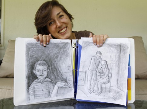 Katie Brubaker with her drawings of Peter Zucca.