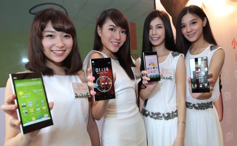 Chinese models show off Xiaomi smartphones in Hong Kong. Photo: Thomas Yau