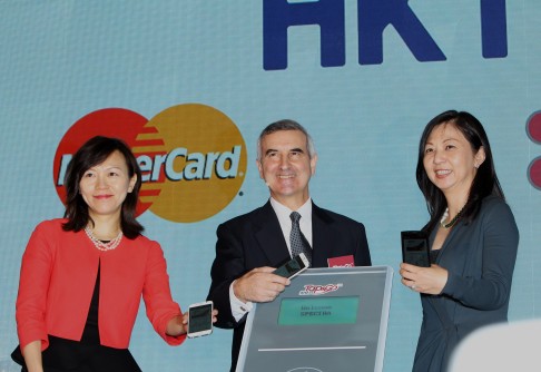 Alex Arena, managing director of HKT Group (centre) announces a new electronic transaction system in Hong Kong last month. Photo: Franke Tsang