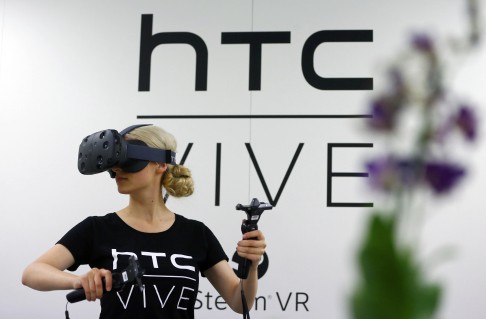 HTC is looking to diversify its products as its share of the smartphone market has shrunk considerably. Here, a woman checks a pair of the company's Vive Virtual Reality goggles at a trade fair in Germany earlier this month. Photo: Reuters