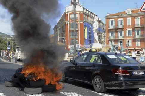 Anti-Uber protests in France in June turned violent as striking taxi drivers set cars on fire. Photo: Reuters
