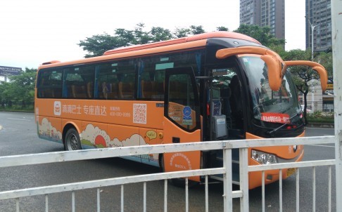 Didi Kuaidi's orange shuttle buses recently started operating in two Chinese cities, Shenzhen and Beijing, as part of a trial project. Photo: He Huifeng