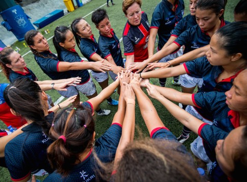 Head coach Anna Richards (centre right), captain Royce Chan (centre left) and the Hong Kong squad get together before heading to Ireland.