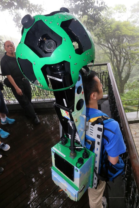 A man demonstrates a Street View Trekker from Google, which is equipped with a camera, at The Peak in Hong Kong. Citymapper looks set to give Google Maps a run for its money in the city. Photo: David Wong