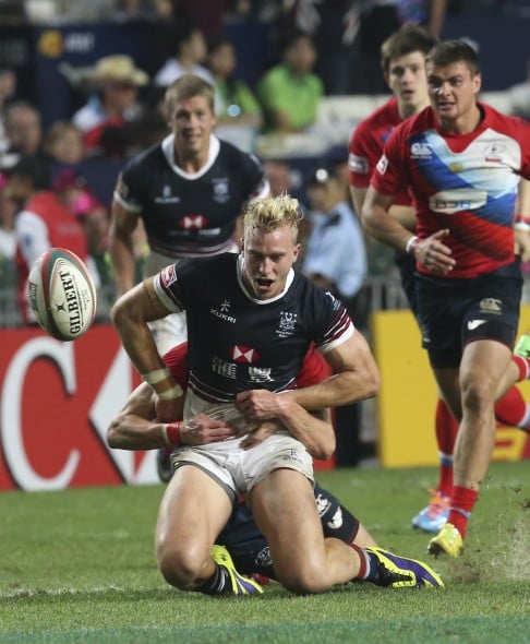 Max Woodward (centre) is tackled by a Russian player during this year's Hong Kong Sevens.