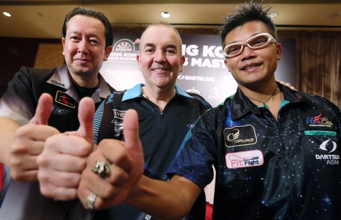Hong Kong's Scott Mackenzie (left) and Royden Lam with Phil Taylor meet the press to promote the Hong Kong Darts Masters. 