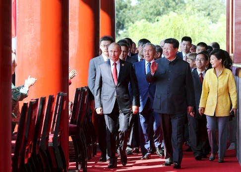 Chinese President Xi Jinping (centre) arrives with world leaders and dignitaries, including Russia's Vladimir Putin (left) and South Korea's Park Geun-hye (right). Photo: Reuters