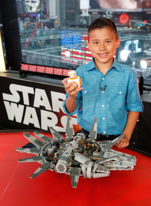 A boy displays the Lego Star Wars Millennium Falcon and the Star Wars BB-8 app-enabled droid after he unboxed toys on a US TV show. Photo: Invision for Disney Consumer Products