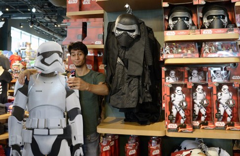 A customer takes a selfie next to a figure of an Imperial Stormtrooper in a US store. Photo: EPA