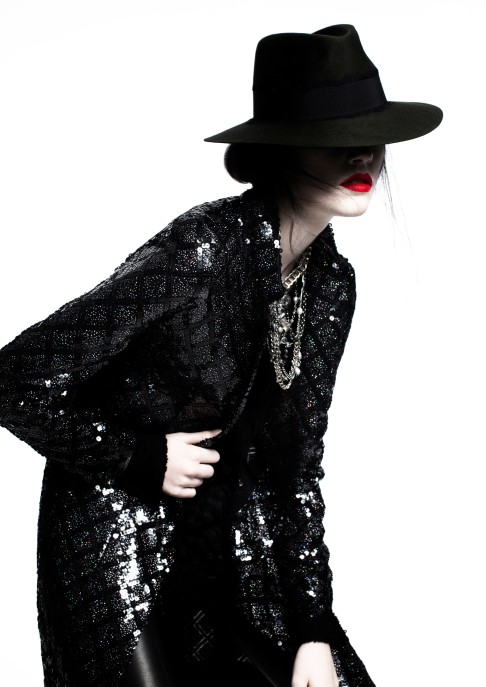 A Byronesque model wears vintage 90's Chanel sequin long jacket, Byronesque vintage 1990 S/S Masion Martin Margiela top, Emanuel Ungaro leather leggings, Maison Michel fedora hat, Goossens Paris for JOYCE necklace, and Catherine Osti cuffs. 