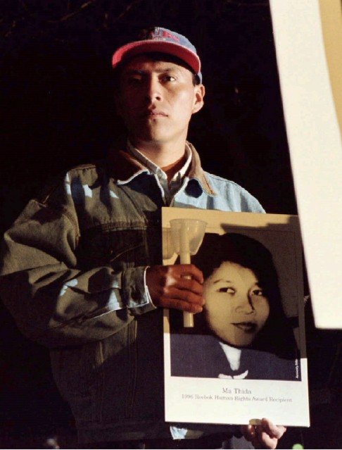Reebok Human Rights award winner Jesus Tecu Osorio, from Guatemala, holds a picture of Ma Thida, at an International Human Rights Day candlelight vigil in Boston, in the United States, in 1996.