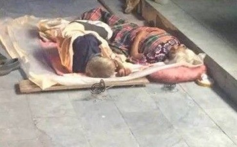 In August 2015, an elderly man died after being run over by a car while sleeping beside his wife on the ground outside a hotel in Zhengzhou city. The couple were seen here in a surveillance photo before the tragedy. Photo: SCMP Pictures