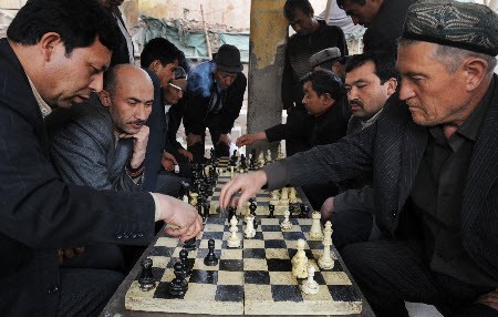 Chinese Uyghur Muslim men play chess in the city of Urumqi in China's western Xinjiang Province. Photo: AFP