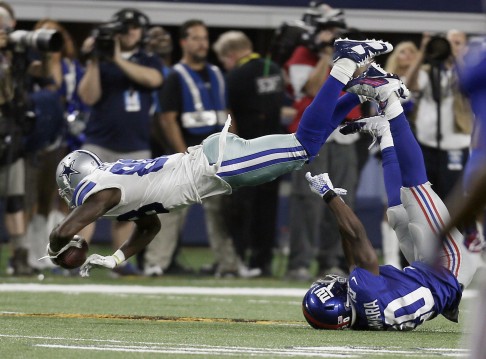 Dallas Cowboys wide receiver Dez Bryant (88) topples over New York Giants cornerback Prince Amukamara (20) during the second half Photo: AP