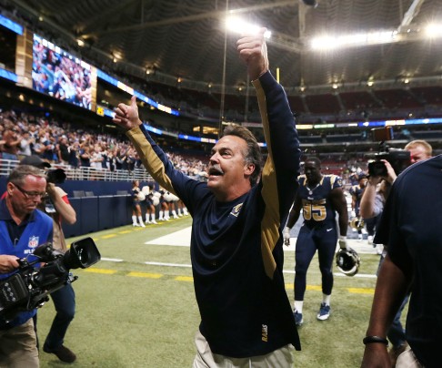 St. Louis Rams head coach Jeff Fisher gestures to the fans as he walks off the field. Photo: TNS