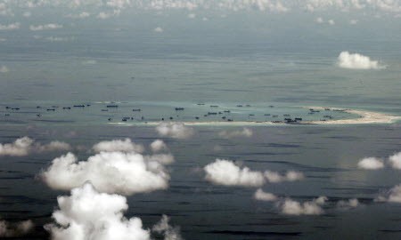 A photo taken though a glass window of a Philippine military plane in May 2015 of alleged land reclamation by China on Mischief Reef in the Spratly Islands. Photo: Reuters