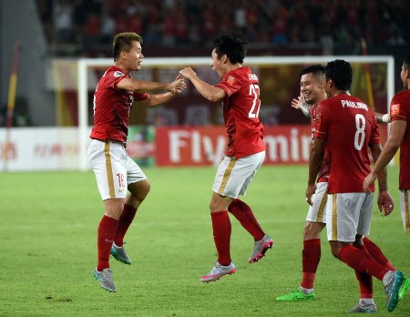 Guangzhou's Huang Bowen (left) celebrates with teammates after scoring the equaliser.