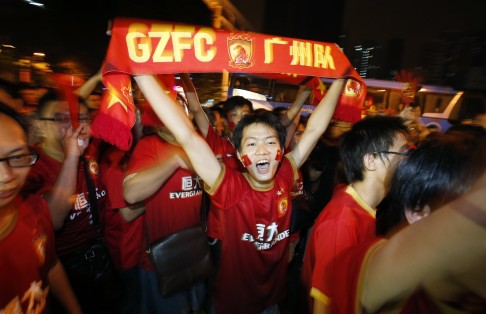 Fans of Chinese football team Guangzhou Evergrande celebrate after their team won AFC Champions' League final in 2013. Ma bought half the team, reportedly after a night out drinking with its owner. Photo: Reuters