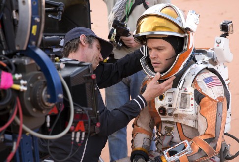 Matt Damon is helped into his suit on the set of The Martian.<br />
