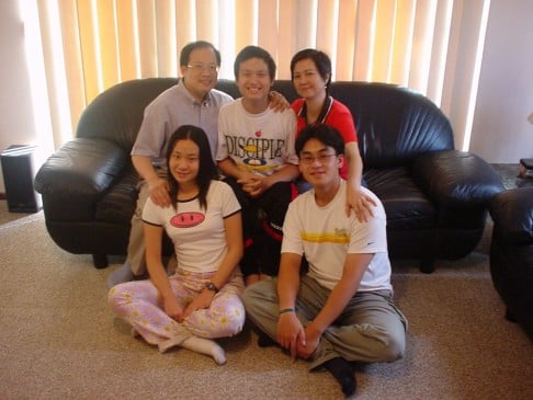 A teenaged Louis Wong (rear, centre) flanked by his parents and with his siblings in foreground.