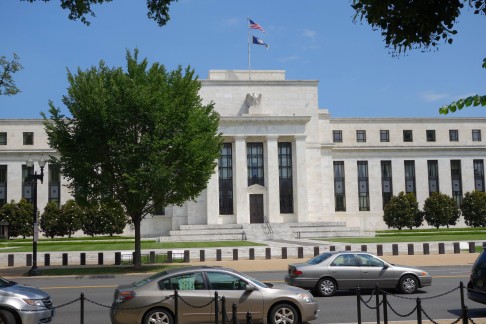 Cars roll by the headquarters in Washington of the Federal Reserve, which has emerged as a key factor in deleveraging for the markets. Photo: AFP