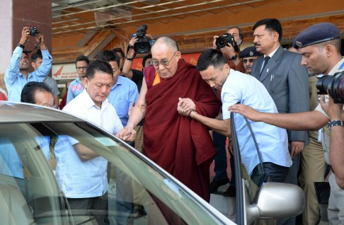 The Dalai Lama helped into a car after arriving in India.Photo: AFP