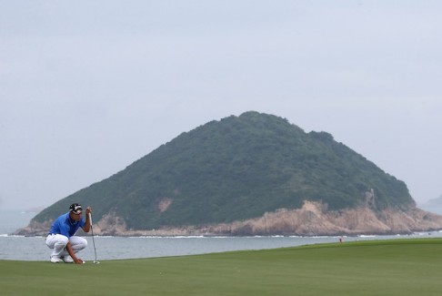 China's Jin Cheng lines up a putt. 