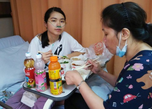 The resilient teen pictured eating dinner with her mum, Imelda Lo. Photo: Handout