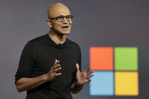 Microsoft CEO Satya Nadella closes a presentation of new devices in New York on Tuesday. He said this is part of Microsoft's vision 'to move people from needing Windows to choosing Windows to loving Windows.' Photo: AP