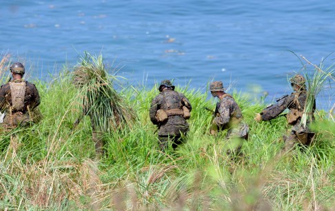 US Marine snipers take position during a beach landing as part of annual joint naval exercises with the Philippines. Photo: AFP