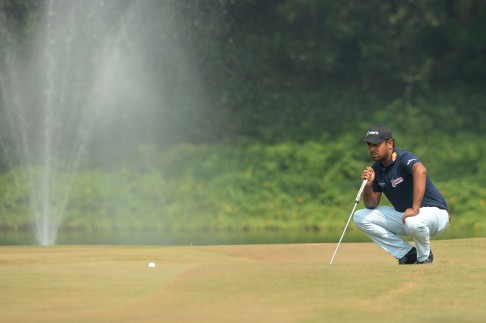 Anirban Lahiri of India lines up a putt during the second round of the Macau Open. Photo; AFP 